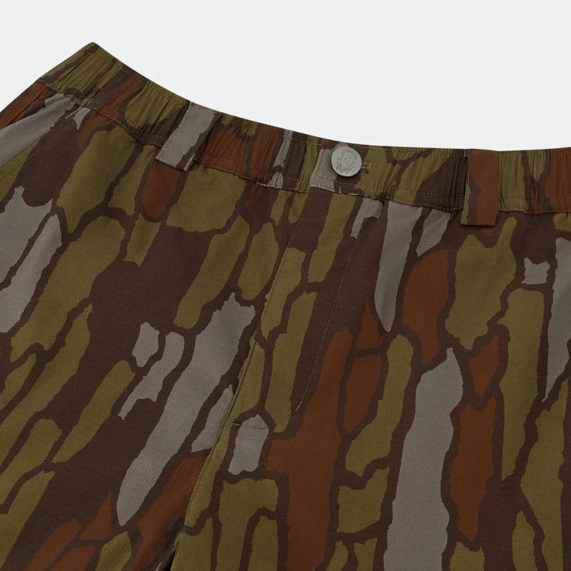 Trebark Camouflage-patterned shorts with a silver button on a white background