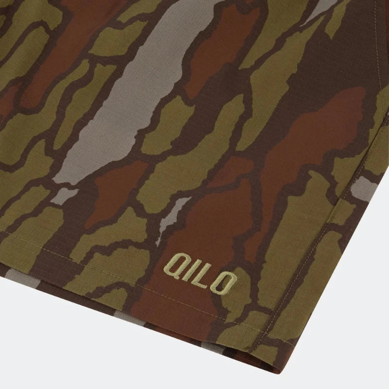 Trebark Camouflage-patterned fabric with 'Qilo' branding on a white background