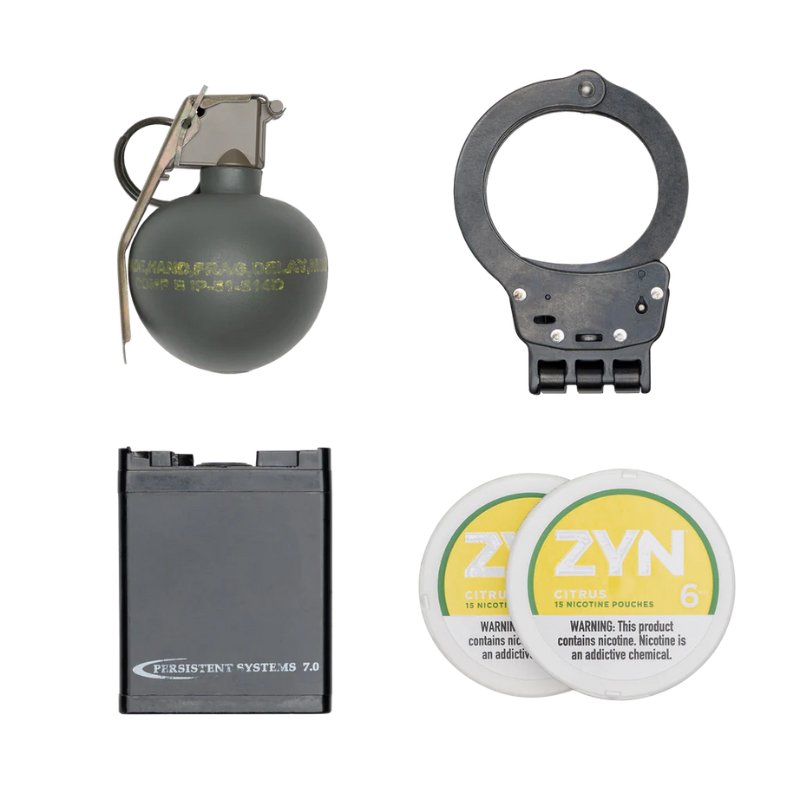 Assorted gear carried by Frag Bag™: M67 frag grenade, handcuffs, MPU5 battery, and two Zyn nicotine tins