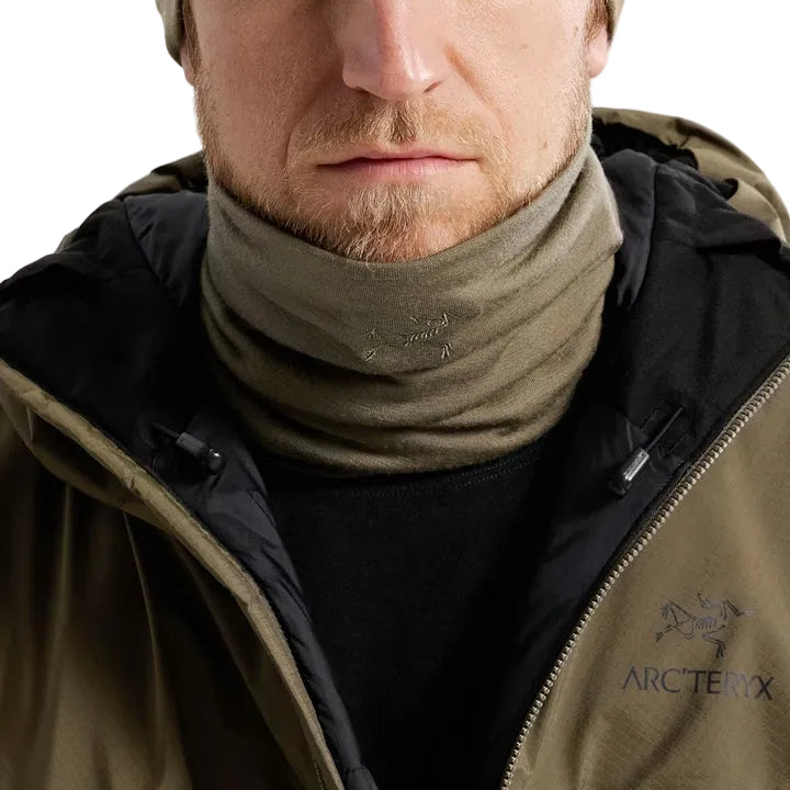 Image of the Arc'teryx Cold WX Neck Gaiter AR Wool in Crocodile being worn and layered in a cold-weather environment, showing the lightweight merino wool construction, low-profile fit, and heat-retaining design. Highlights moisture-wicking performance, stretch mobility, and winter-ready protection ideal for tactical cold weather operations and backcountry conditions.