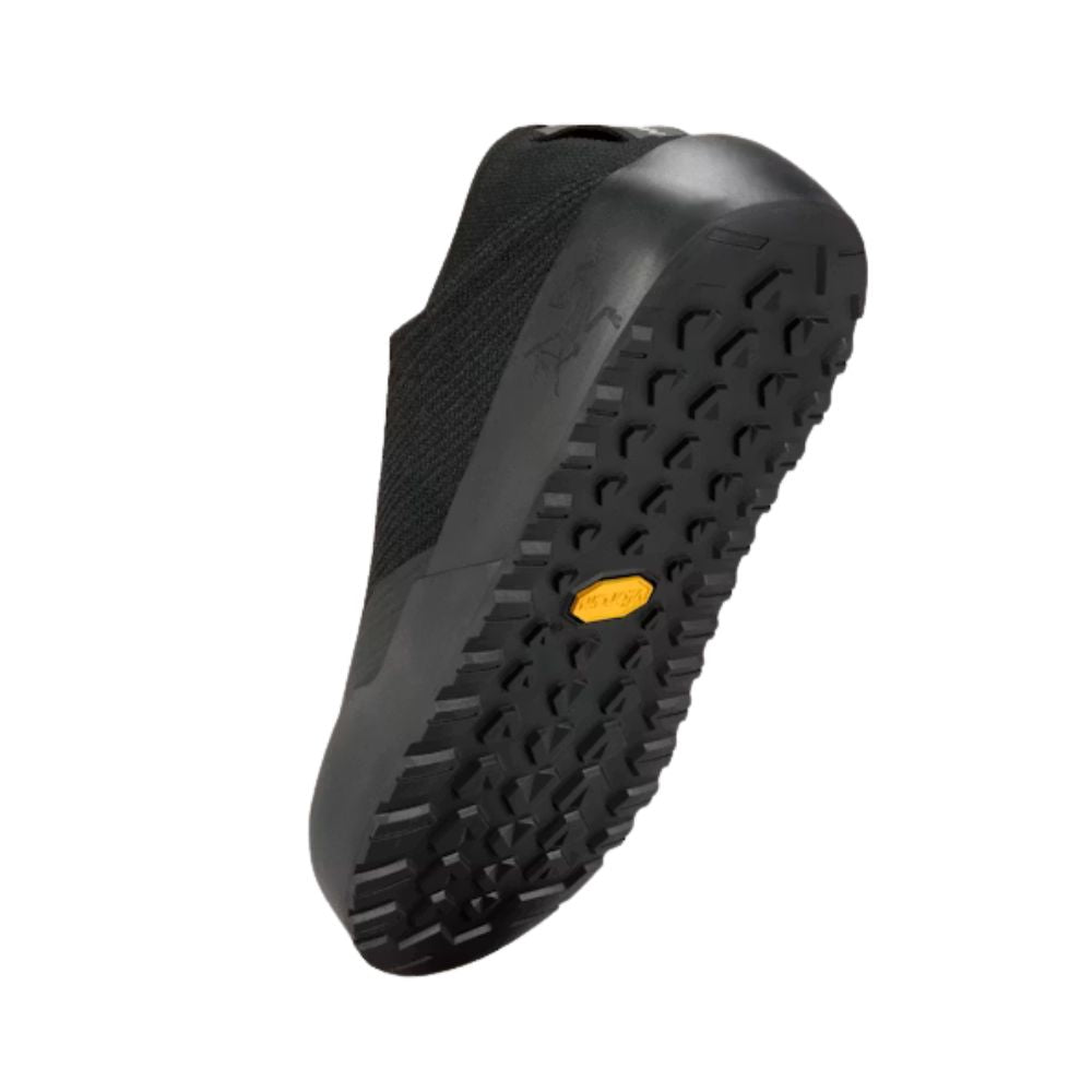 Bottom view of the Arc'teryx Kragg Shoe in Black highlighting the Vibram Megagrip outsole with optimized approach lugs for traction on rock, dirt, and mixed terrain.