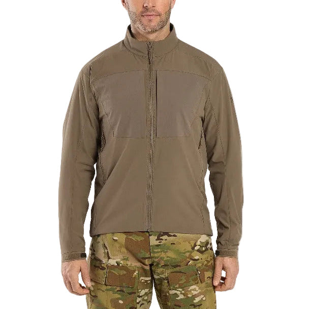 Lifestyle image of the Arc'teryx LEAF Practitioner AR Jacket in Crocodile being worn, showing the articulated fit, breathable Fortius Air 50 fabric, and lightweight Octa Loft insulation designed for high mobility and temperature regulation during tactical movement and outdoor missions.