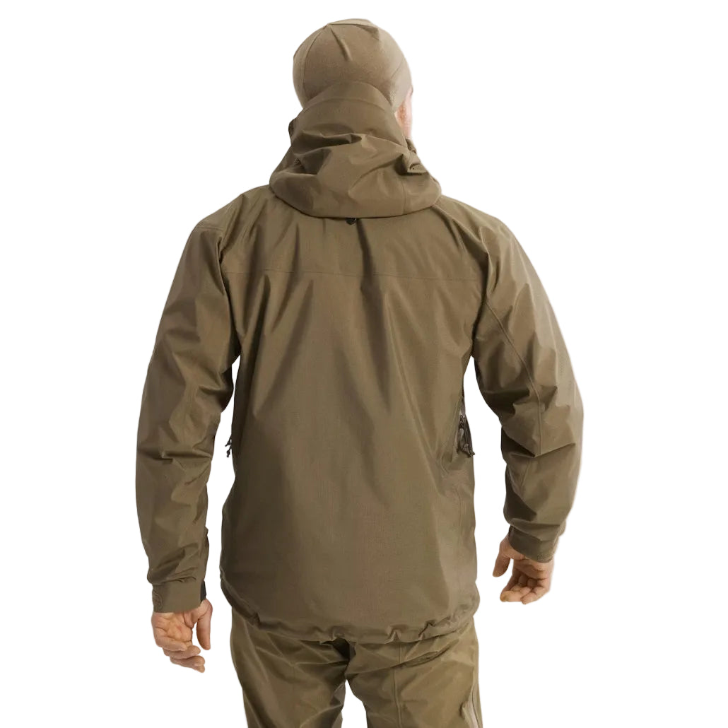 Back view of the Arc'teryx PRO Alpha LT Jacket Gen 2.2 in Crocodile being worn, showing the military fit patterning, streamlined hood design, and lightweight GORE TEX 3 layer construction. This PRO-series shell, evolved from the former Arc'teryx LEAF line, is built for wet weather tactical operations and high mobility field use.