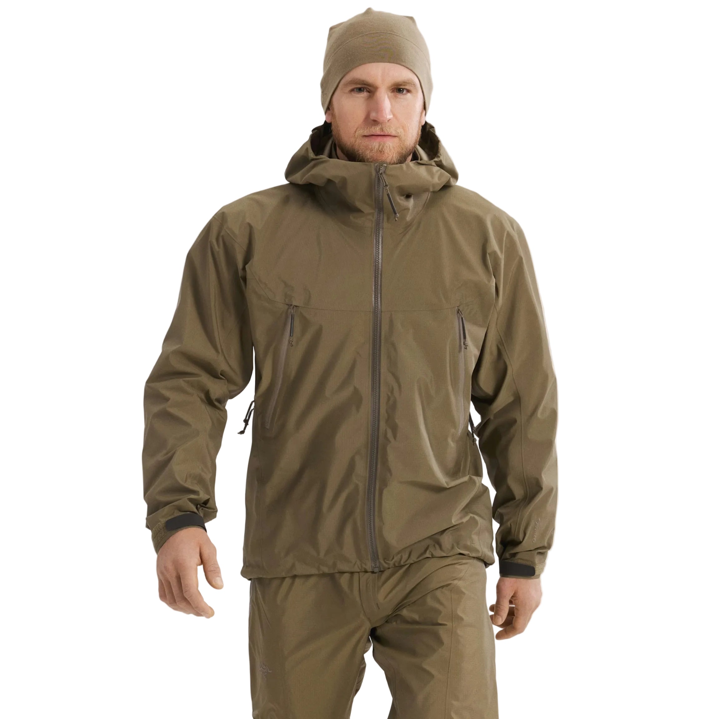 Front view of the Arc'teryx PRO Alpha LT Jacket Gen 2.2 in Crocodile being worn, showing the streamlined military fit, lightweight GORE TEX 3 layer shell, and low profile design originally developed under the Arc'teryx LEAF program. Demonstrates weatherproof performance and mobility for tactical operations and high-output field environments.