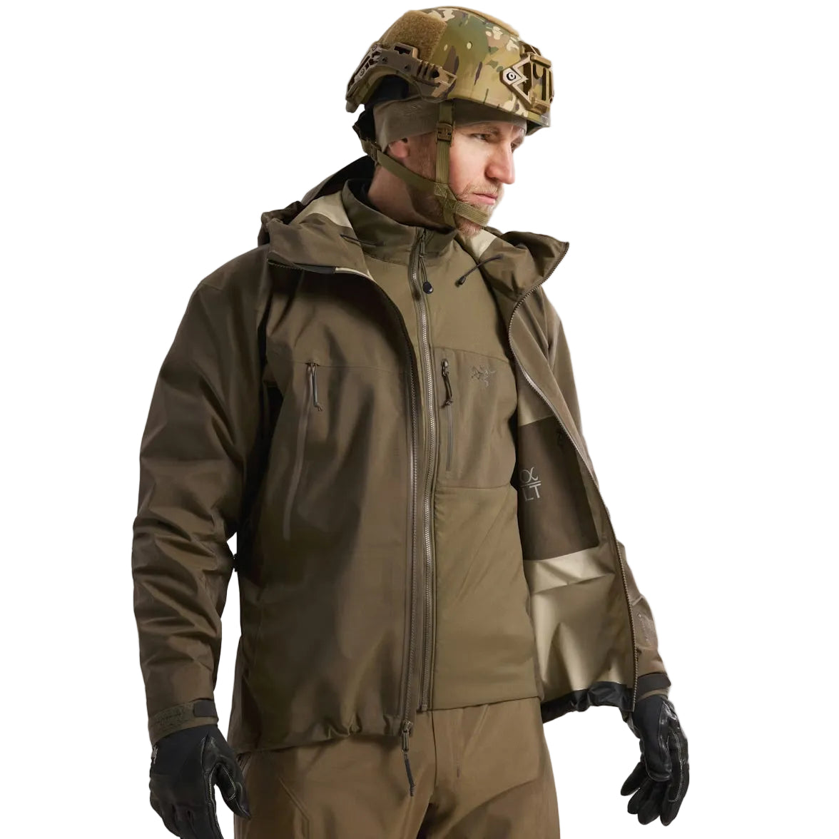 Worn view of the Arc'teryx PRO Alpha LT Jacket Gen 2.2 in Ranger Green worn open and layered over another jacket, showing the lightweight GORE TEX 3 layer shell, military fit, and low profile design originally developed under the Arc'teryx LEAF program. Demonstrates how the PRO Alpha LT functions as a weatherproof outer layer in tactical and high mobility field environments.