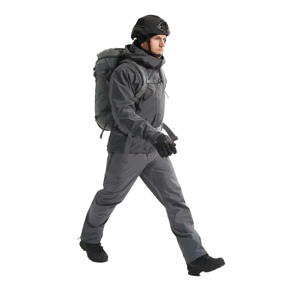 Full body view of the Arc'teryx PRO Alpha LT Jacket Gen 2.2 in Wolf Grey being worn, showing the streamlined military fit, lightweight GORE TEX 3 layer construction, and low profile PRO-series design evolved from the Arc'teryx LEAF line. Demonstrates mobility, coverage, and wet weather protection for tactical field environments.
