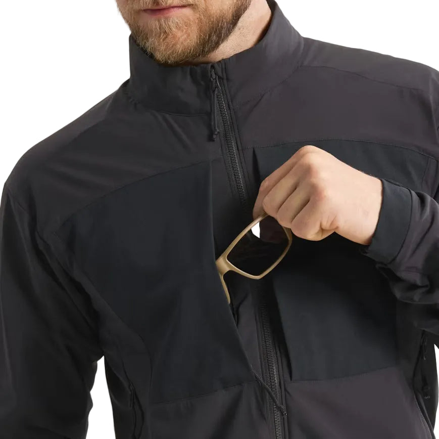 Close-up image of the Arc'teryx PRO Practitioner AR Jacket in Black showing the front chest pocket being used, highlighting the zippered storage, Fortius Air 50 shell, and low-profile tactical design. Demonstrates quick-access organization and mission-ready functionality of the PRO-series mid layer built for field operations and high-output movement.