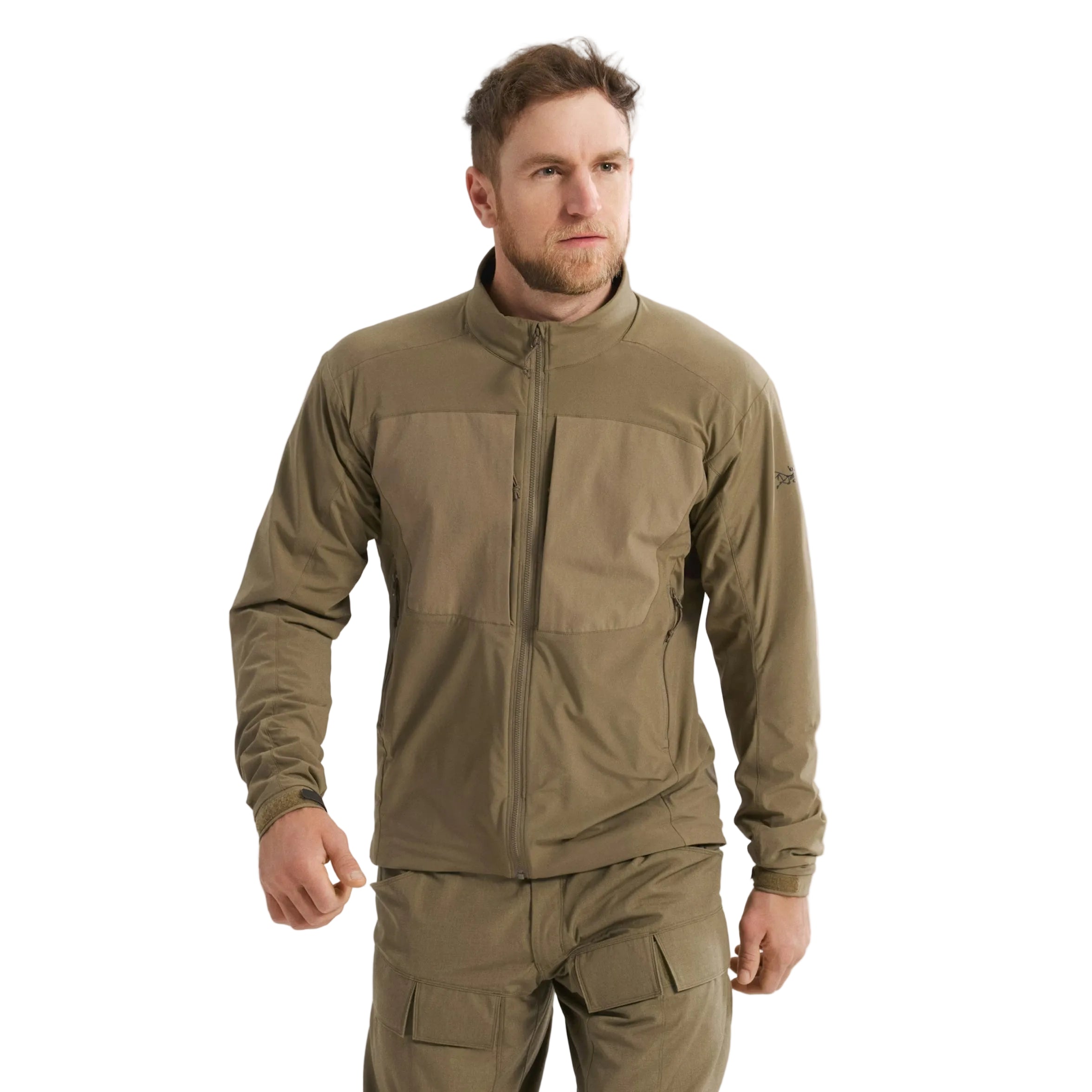 Front view of the Arc'teryx PRO Practitioner AR Jacket in Crocodile being worn, showing the Fortius Air 50 breathable shell, Octa Loft insulation, and articulated fit designed for mobility in tactical environments. Highlights the PRO-series mid layer’s ability to regulate heat, move under load, and deliver mission-ready performance in changing conditions.