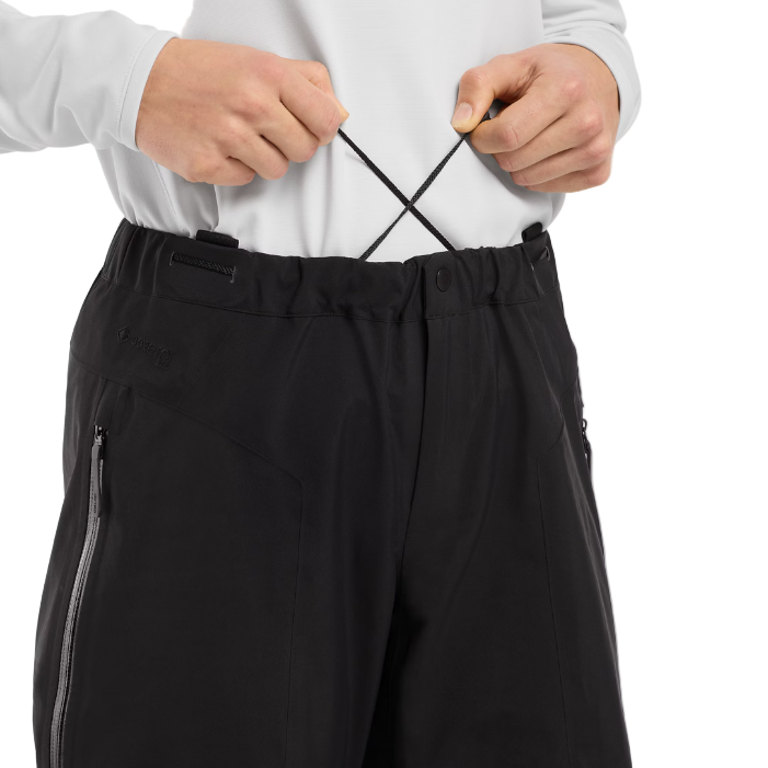 Close view of the Arc'teryx Women’s Alpine Guide Pant showing the elastic waist cinch adjustment straps on the women’s GORE TEX PRO ski guide shell featured in the Arc'teryx on sale winter collection.