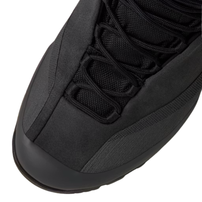 Close-up of a black hiking boot showing the toe, laces, and textured upper against a white background.