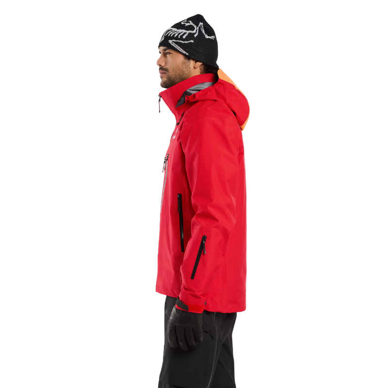 Close-up view of the Arc’teryx Ski Guide Jacket in Dynasty red, showing pro-level features like the helmet-compatible DropHood™, radio-ready chest pocket, and pit zips - professional GORE-TEX PRO gear on clearance.