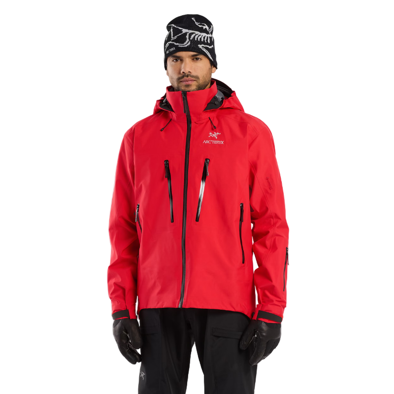Arc’teryx Ski Guide Jacket in Dynasty red shown on a person standing, pro-grade GORE-TEX PRO outerwear built for ski guides, patrol, and rescue - available on clearance.