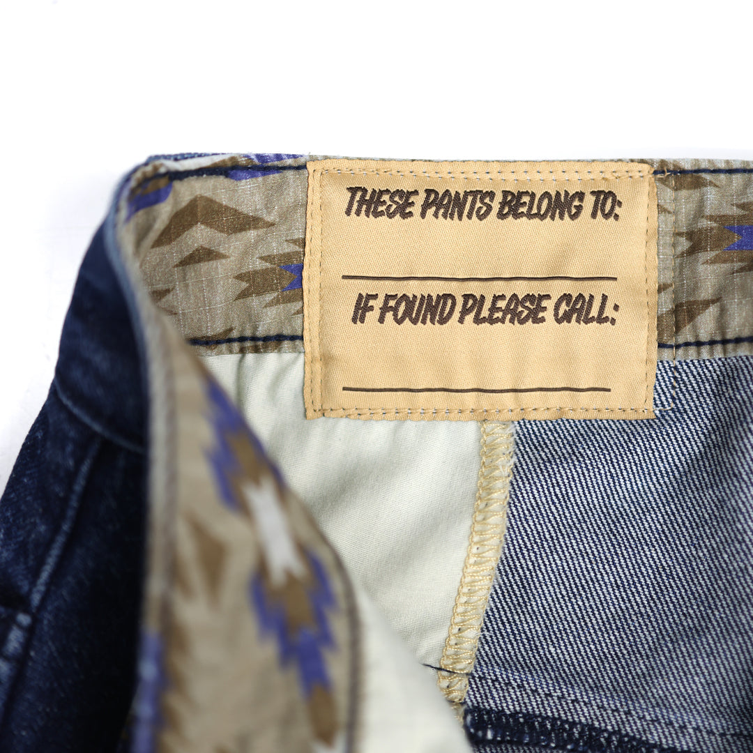Close-up of a label on a pair of pants with text instructions.