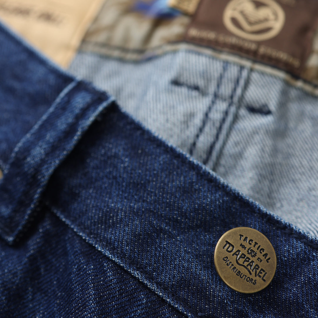 Close-up of blue denim fabric with a brand label on a jeans pocket