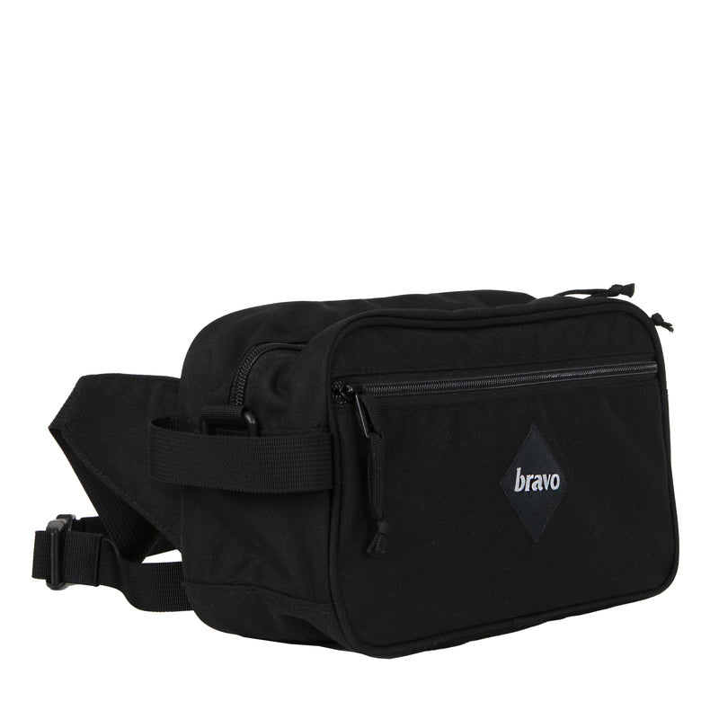 Side profile of the Bravo Co Flee Block I Black highlighting the compact depth, durable Cordura exterior, and carry strap attachment points.