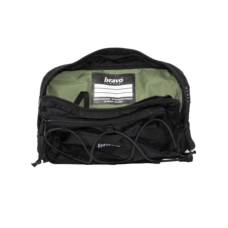 Interior view of the Bravo Co Quarter Block 1 in Ripstop/Black shown unzipped, featuring dual compartments with organizer panel, microfiber-lined eyewear pocket, and 2L storage capacity. Built with ripstop nylon and Cordura® for rugged EDC and tactical versatility.