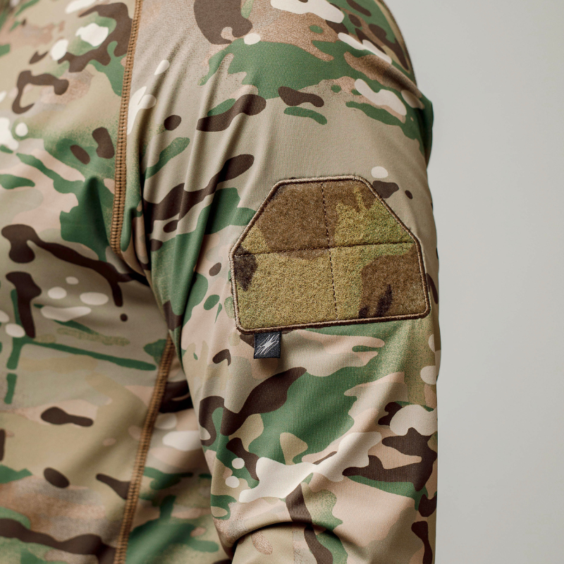 Detailed view of the loop patch panel on the bicep of the MultiCam tactical shooter shirt, perfect for attaching ID or morale patches during operations