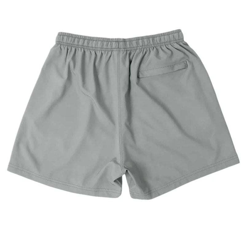 Back view of Cove Charcoal Grey Performance Shorts, made from eco-friendly recycled plastic bottles. Designed with a 5" inseam, these athletic shorts feature an adjustable elastic waistband, drawstring, and a zippered back pocket for secure storage. Perfect for gym, swim, or lounging, they offer a comfortable, flexible fit with moisture-wicking and quick-dry capabilities.