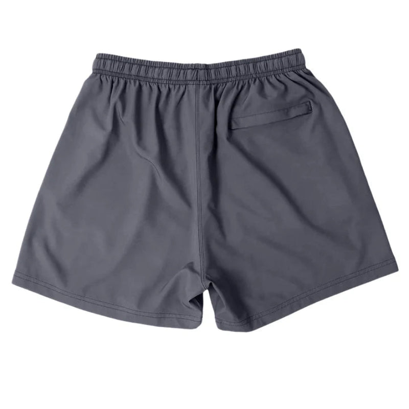 Back view of Cove Grey Gunmetal Performance Shorts made from recycled plastic bottles. These shorts feature a 5" inseam, elastic waistband with drawstring, and a zippered back pocket for secure storage. Crafted with 90% recycled polyester and 10% spandex, offering comfort and mobility for gym, swim, or lounging.