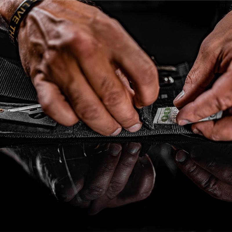 Dynamis Alliance LOPRO Belt showing integrated hidden storage compartments designed for carrying keys, cash, and small EDC essentials.