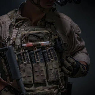 Operator accessing gear from Ferro Concepts MOLLE Admin Panel mounted on plate carrier demonstrating rapid access to tools, notes, and mission essential equipment