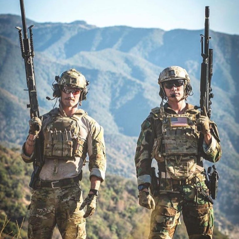 Operators wearing Ferro Concepts The Dangler as part of mission ready plate carrier setup in outdoor environment