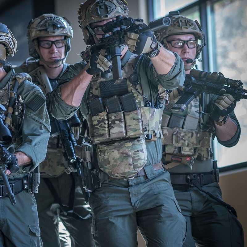 Military personnel wearing plate carriers equipped with Ferro Concepts The Dangler during tactical operations