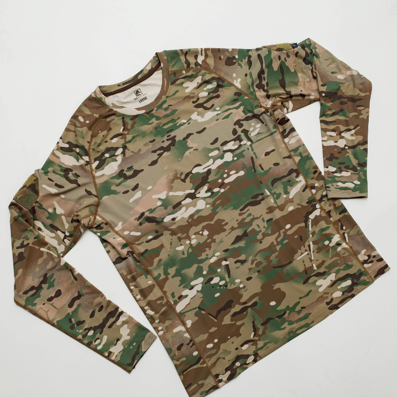 Flat lay of the long sleeve MultiCam range shirt showing tactical design, sleeve patches, and crew neck construction for base layer use