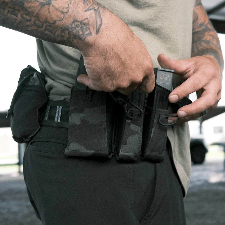 GBRS Group Single Pistol Mag Pouch mounted on belt with shooter accessing magazine during reload