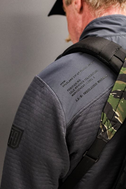 Photo of MTHD Overland Zip-Up Fleece Jacket worn during training drills and everyday work, highlighting Polartec Power Air fabric, tactical athletic fit, and durable mid-layer design for warmth, flexibility, and performance in active environments.