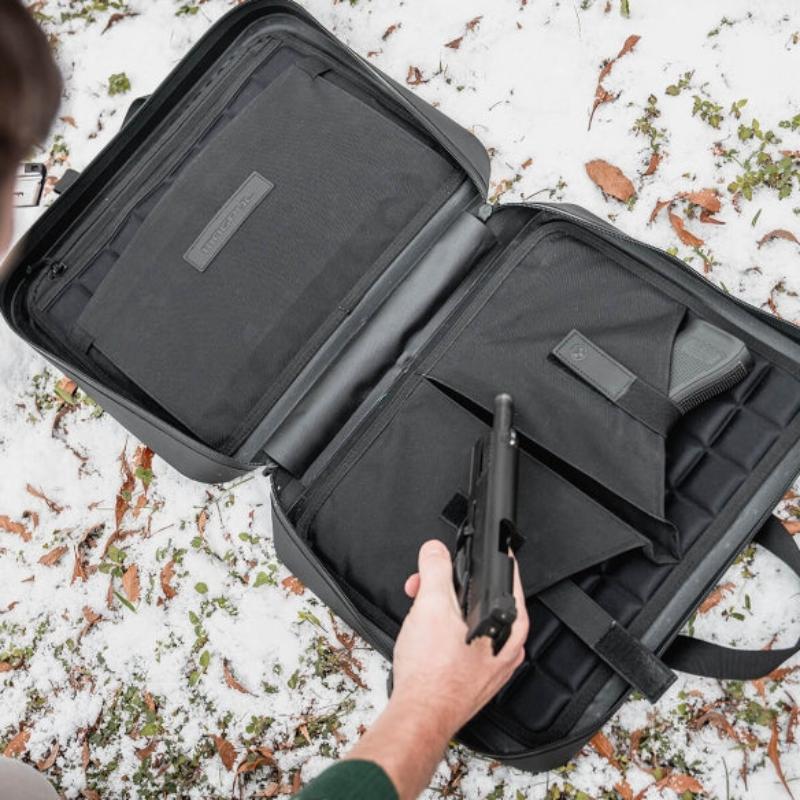 Magpul DAKA Double Pistol Case Black being used at the range holding two pistols and magazines in compact water resistant storage case