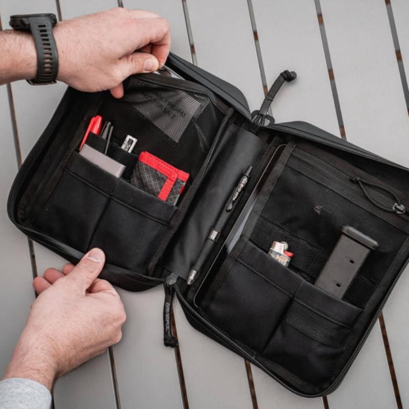 Magpul DAKA Utility Organizer Large Black used as travel admin pouch organizing electronics cables and documents inside backpack