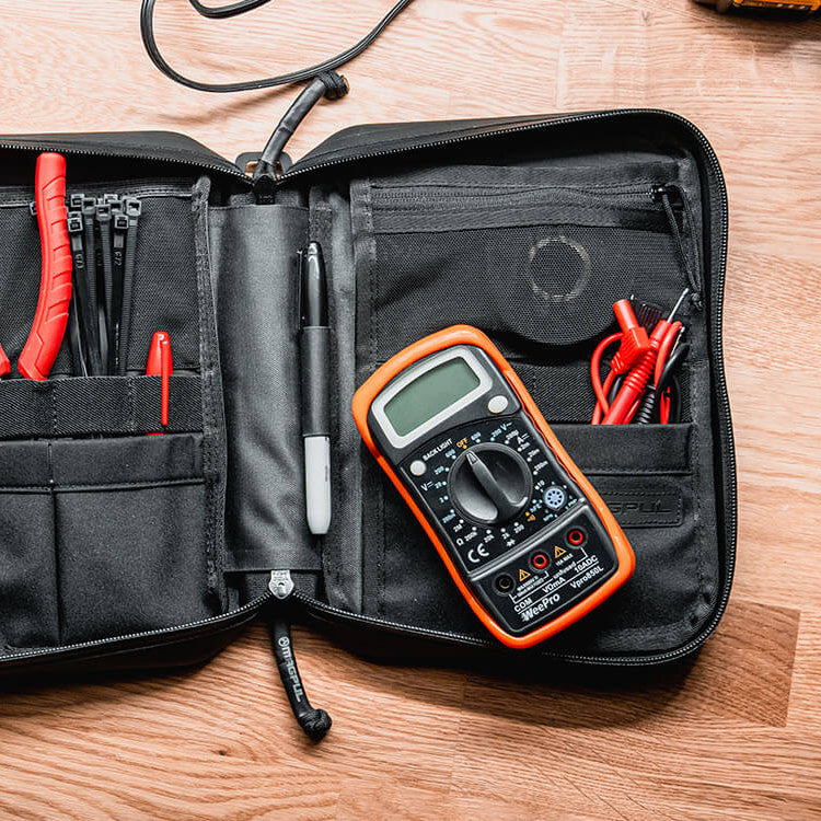 Magpul DAKA Utility Organizer Large Black holding tools and small equipment on workbench highlighting durable structured utility storage