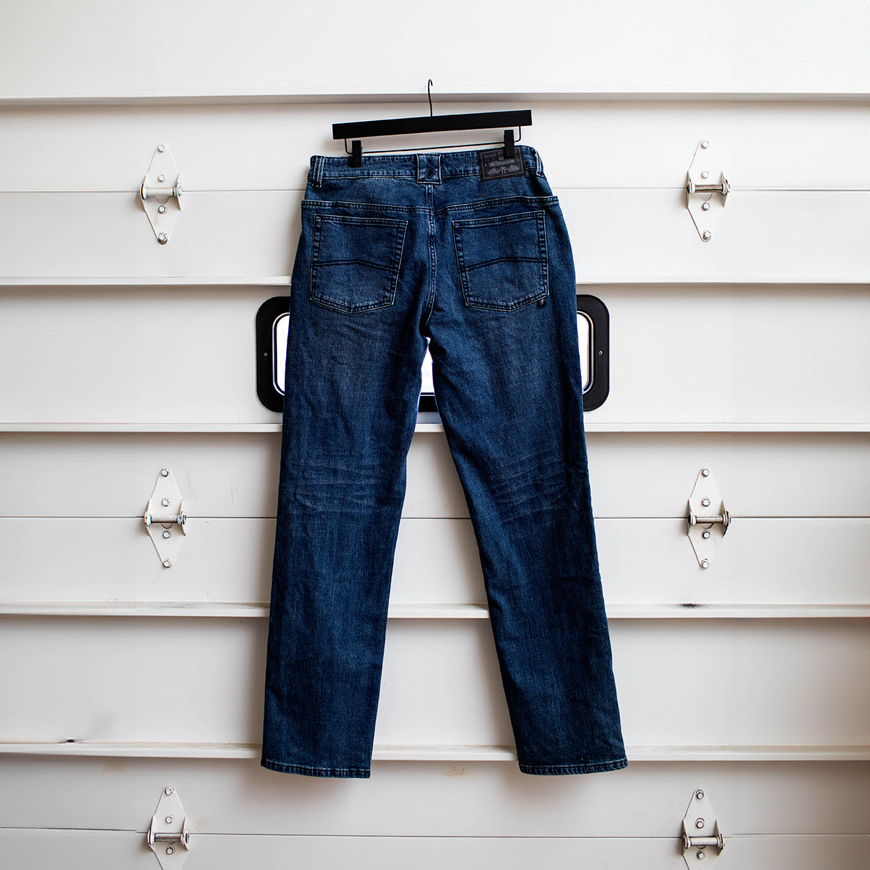 Back view of the TD McQuade Tactical Jeans in the Marlboro wash shown hanging, highlighting the reinforced rear pockets, AR mag compatible EDC yoke pockets, tactical denim construction, and concealed carry friendly design for users searching for the best tactical jeans and everyday carry denim.