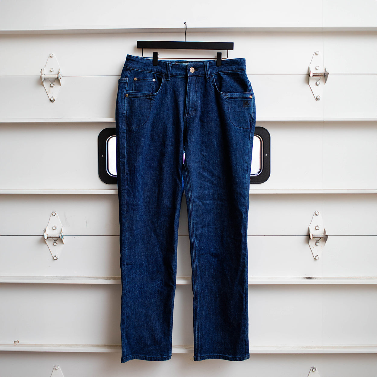 TD McQuade Tactical Jeans in the Midnight wash shown hanging, highlighting the stretch tactical denim construction, reinforced belt loops, concealed carry friendly waistband, and ten pocket EDC layout for users searching for the best tactical jeans, CCW pants, and everyday carry denim.