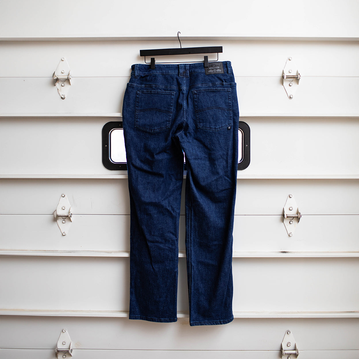 Back view of the TD McQuade Tactical Jeans in the Midnight wash shown hanging, highlighting the reinforced rear pockets, AR mag compatible EDC yoke pockets, and concealed carry optimized stretch tactical denim for users searching for the best tactical jeans, CCW pants, and everyday carry denim.