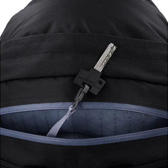 Detail view of the Outdoor Research Adrenaline Day Pack 30L in black, highlighting the secure interior key clip feature for organizing essentials inside the lightweight alpine pack.