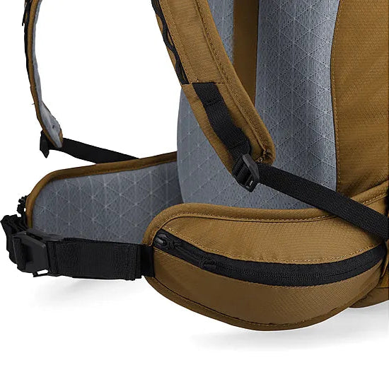 Detail view of the Outdoor Research Adrenaline Day Pack 30L in coyote, showing padded waist strap with zippered storage pockets for secure, comfortable load carry on alpine or tactical missions.