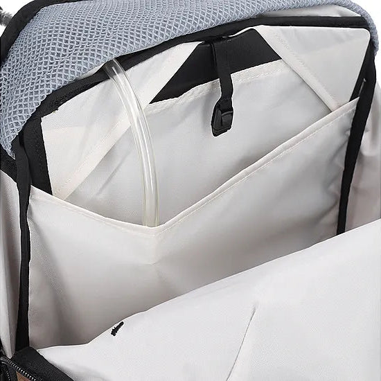 Interior view of the Outdoor Research Adrenaline Day Pack 30L in titanium, showing multiple storage pockets, hydration sleeve, and secure compartments for organized alpine gear carry.