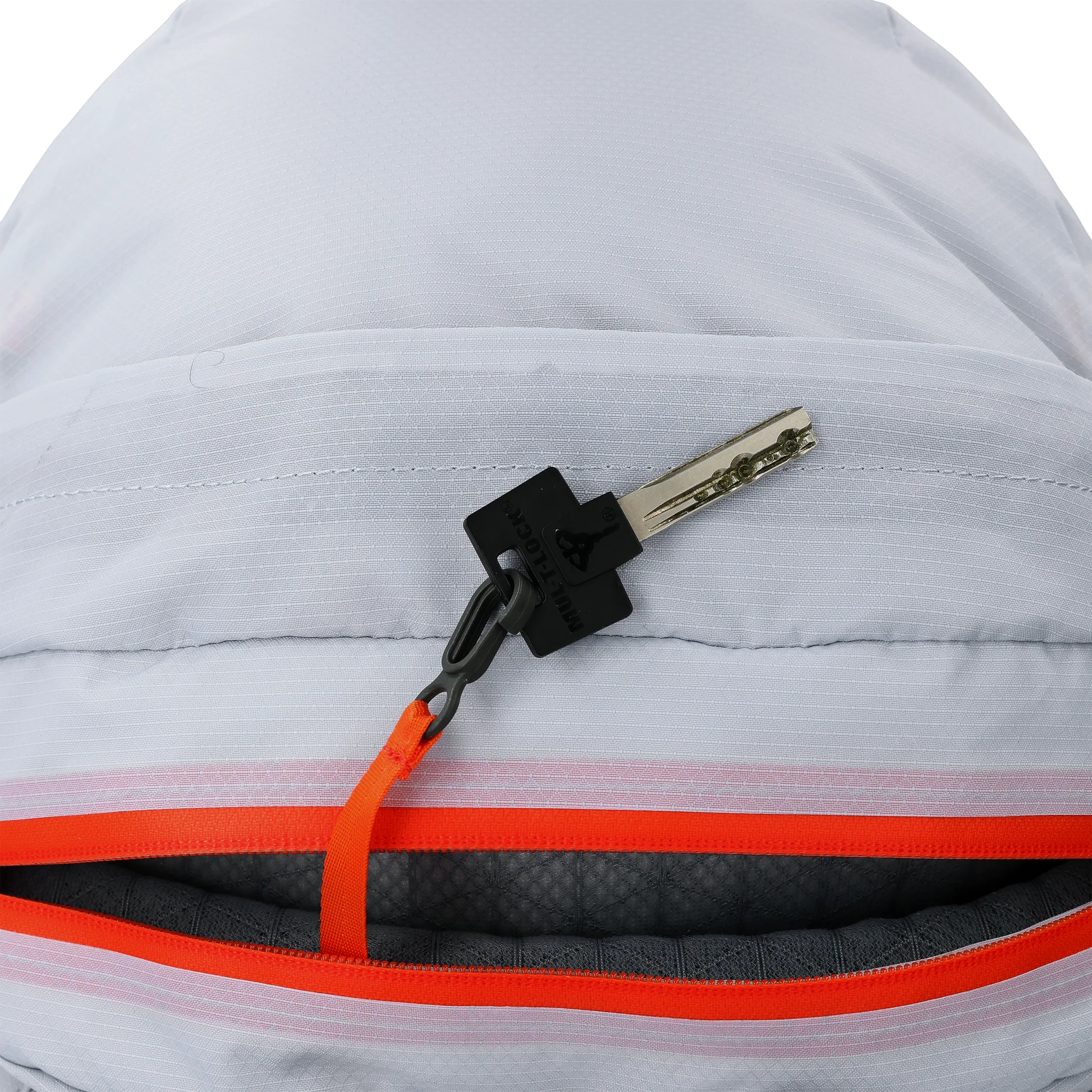 Detail view of the Outdoor Research Adrenaline Day Pack 30L in titanium colorway, highlighting the secure interior key clip for organizing essentials inside the lightweight alpine pack.