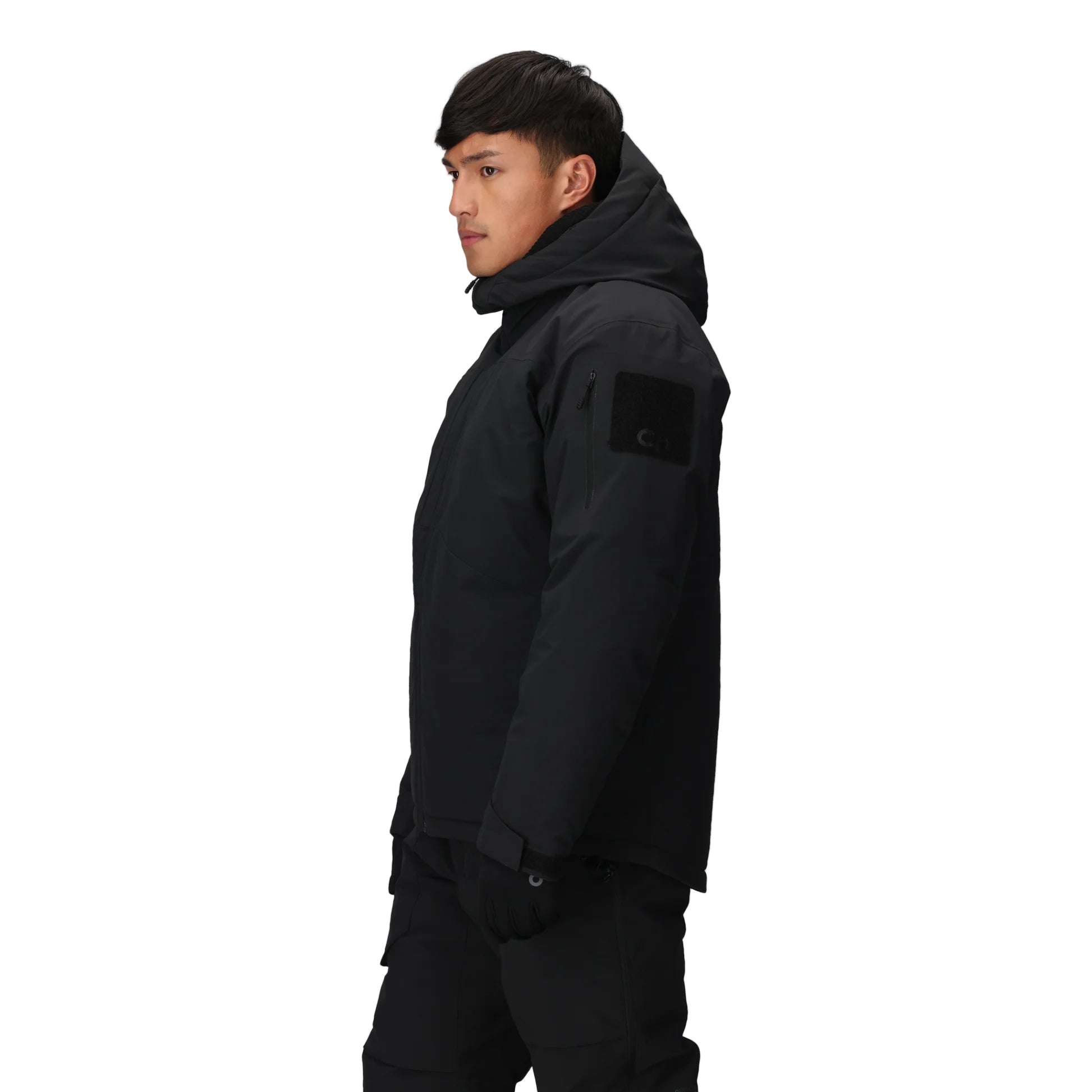 Three-quarter side view of the Outdoor Research Allies Colossus II Parka in black, showing zippered chest pocket, shoulder patch panel, and weatherproof shell for operational advantage.