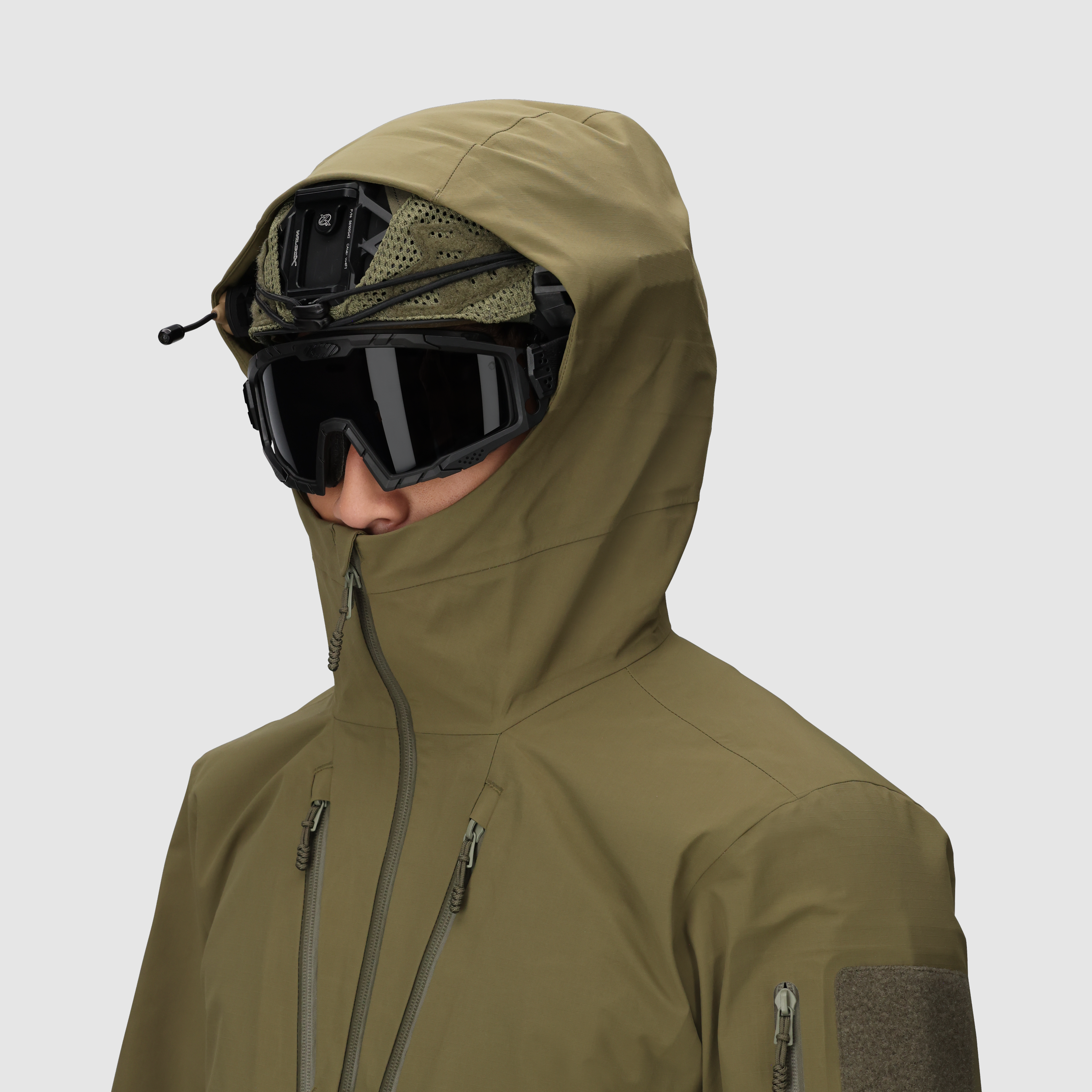 Outdoor Research Allies Mountain II Jacket in Ranger Green with the hood up and front fully zipped, showing the helmet compatible hood, weatherproof AscentShell construction, and durable Cordura ripstop design built for military, law enforcement, and alpine professionals operating in extreme storms and rugged terrain.