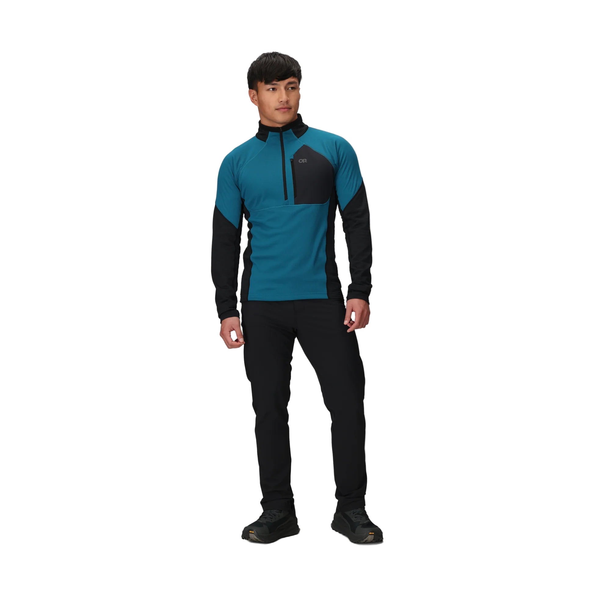 Full body view of the Outdoor Research Deviator Fleece Half Zip in Aurora teal and black, shown on a model with ergonomic fit, hybrid construction, and technical midlayer design for alpine, hiking, and cold-weather missions.