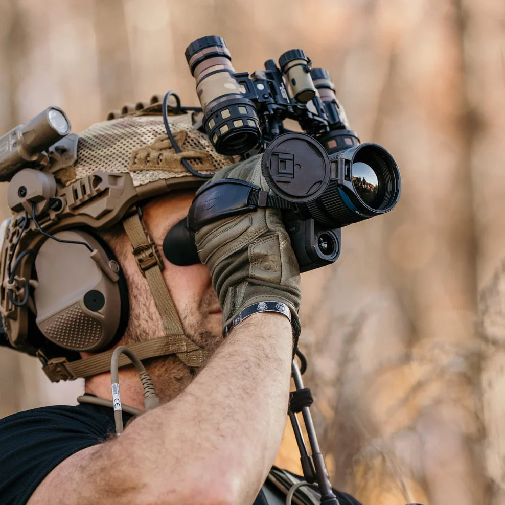 Operator wearing Outdoor Research Ironsight II FR Gloves in Ranger Green during live field operations, flame resistant Nomex and Kevlar tactical duty gloves integrated into full combat gear for military missions, range training, and law enforcement duty applications