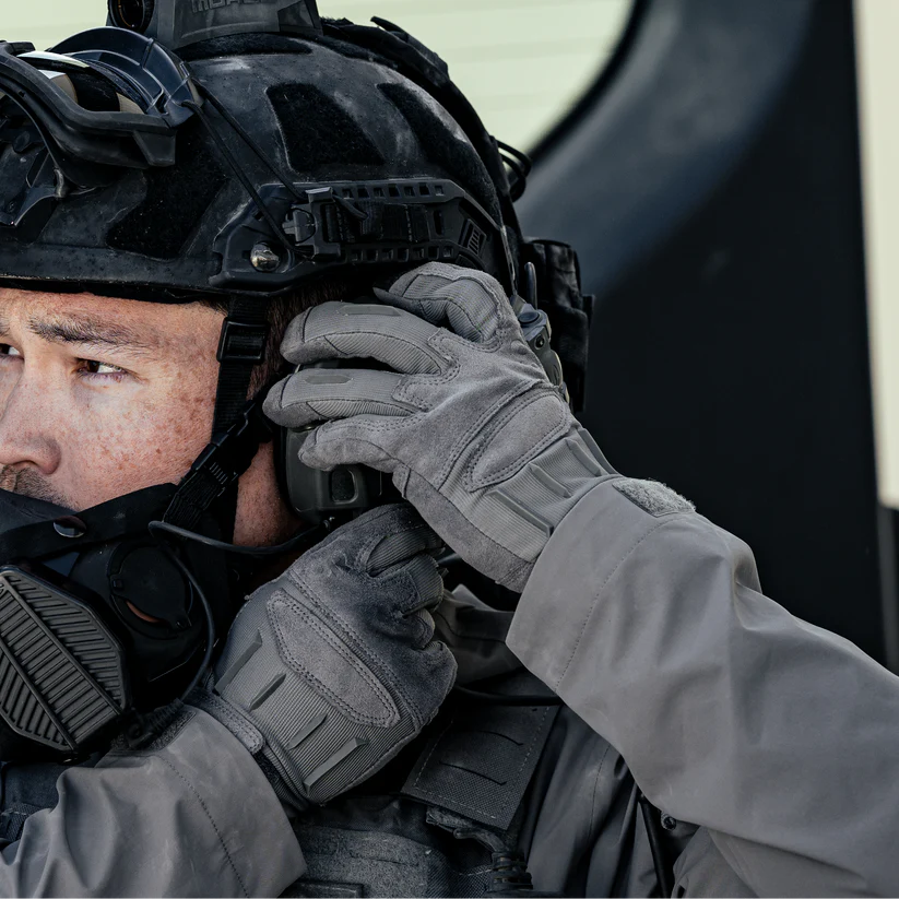 Wolf Grey Outdoor Research Ironsight II Gloves worn in a tactical field environment, showing dexterity, secure grip, and breathable construction during real use. Optimized for searches related to tactical shooting gloves, EDC gloves, and durable field-ready hand protection.