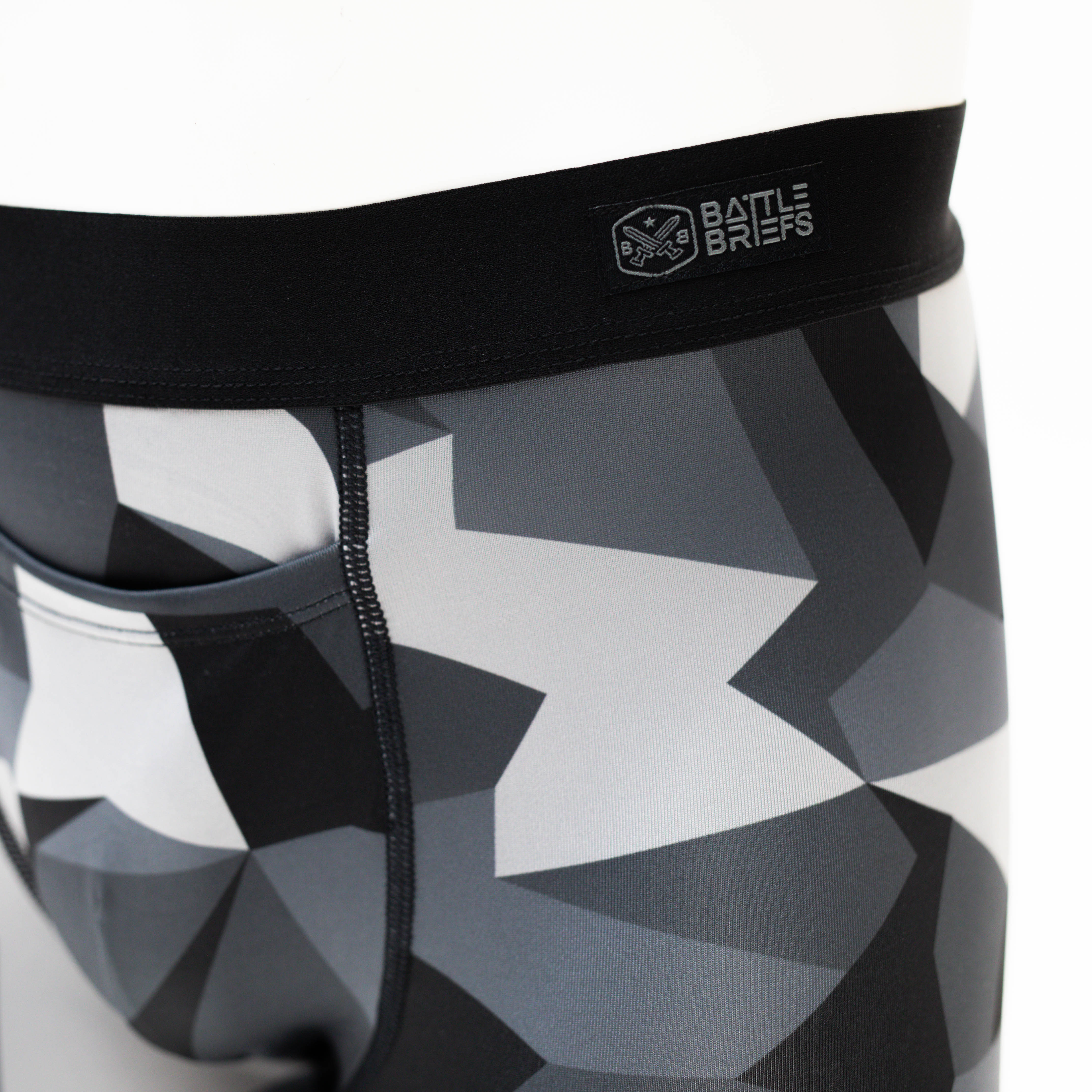 Close-up of the simplified waistband on Battle Briefs Men’s Performance Boxer Briefs in Night M90 camo. Featuring a plush elastic waistband for a secure fit and comfort, these tactical boxer briefs combine moisture-wicking, quick-drying fabric with anti-microbial technology for all-day performance.
