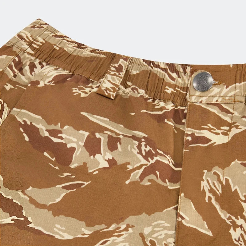 Desert Tiger Stripe Camouflage-patterned shorts with a button on a white background