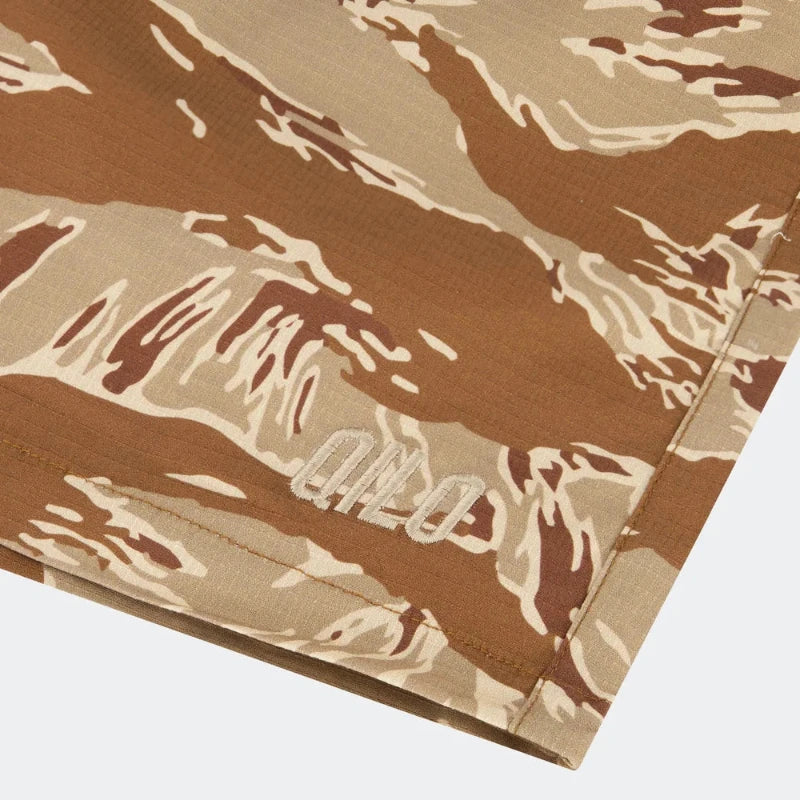 Desert Tiger Stripe Camouflage-patterned fabric with a brand logo on a white background