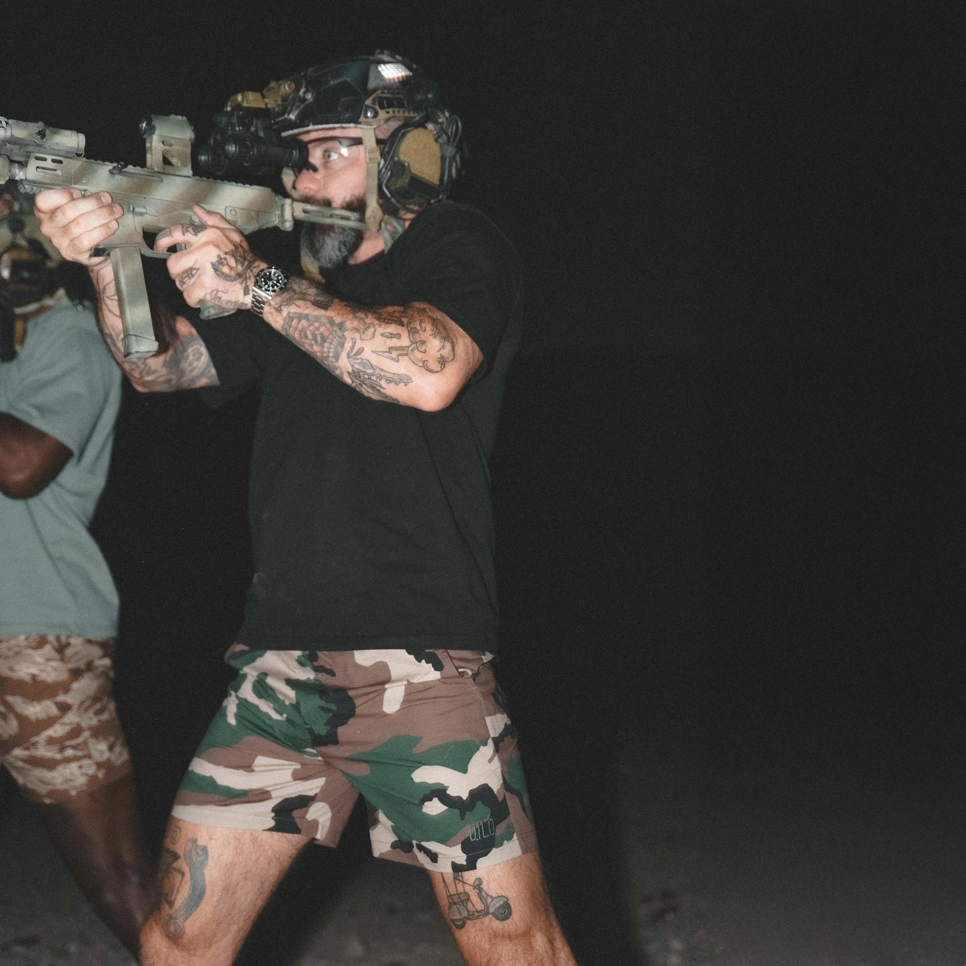 Lifestyle photo of the QILO x WRMFZY Mk. II Shorts in action, from the gun range to laid-back hangs. Rugged tactical fit meets off-duty comfort and style.
