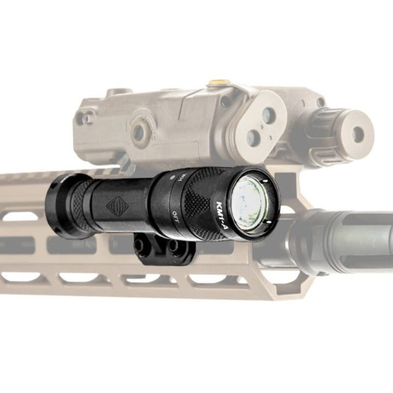 Close-up view of the Reptilia TORCH M-LOK Light Body in Black mounted on a rifle with an active weapon light, highlighting secure billet-aluminum construction and low-profile M-LOK fit. Engineered for SureFire M300 Scout bezels and top-mounted aimers like ATPIAL and PEQ-15. Factory-spec tactical light mount built for durability, precision, and mission-ready performance.